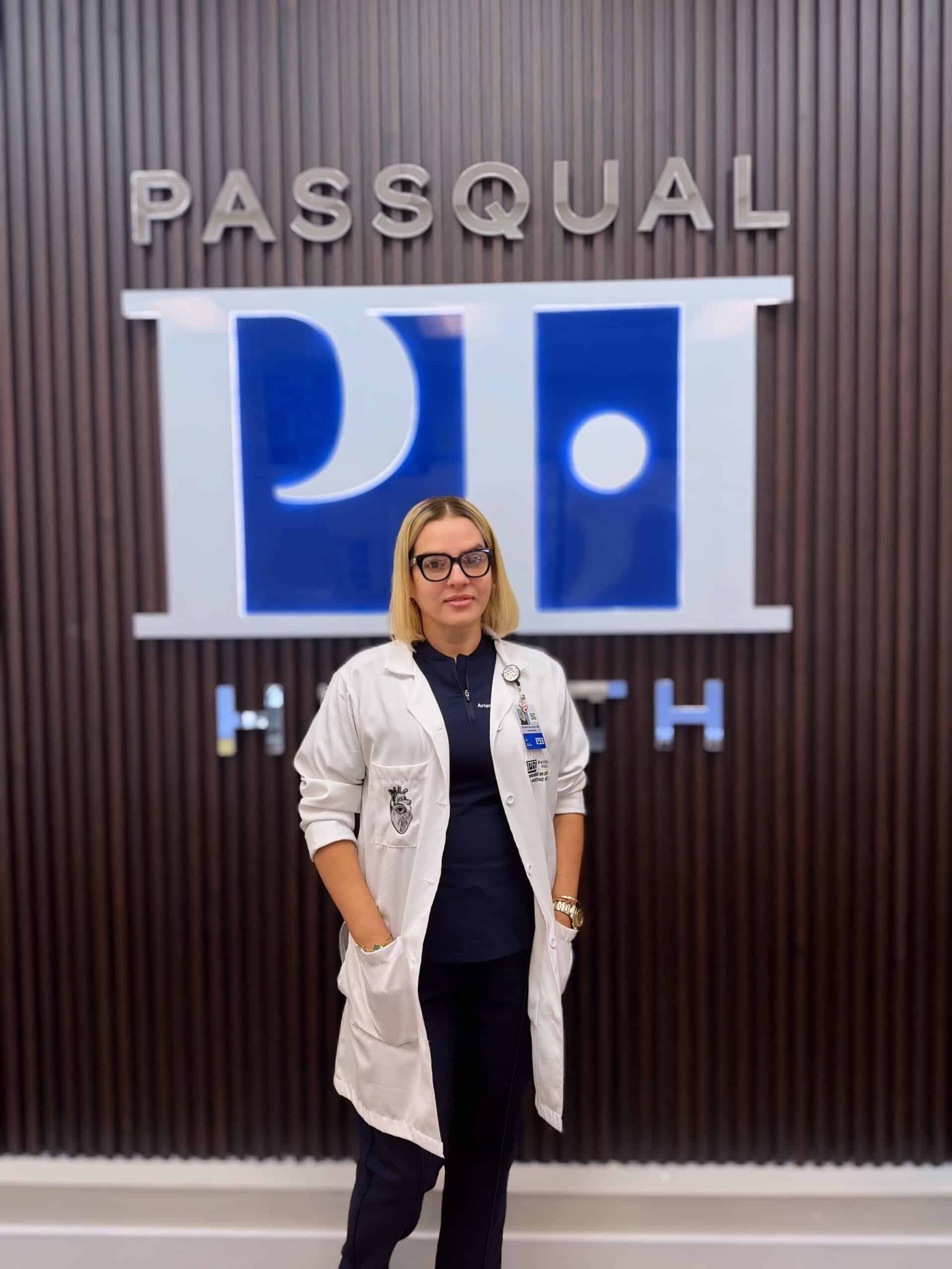 Portrait of Dr. Arlenis Barroso Perez, MD, COO and co-founder of PassQual Health, wearing a white coat
