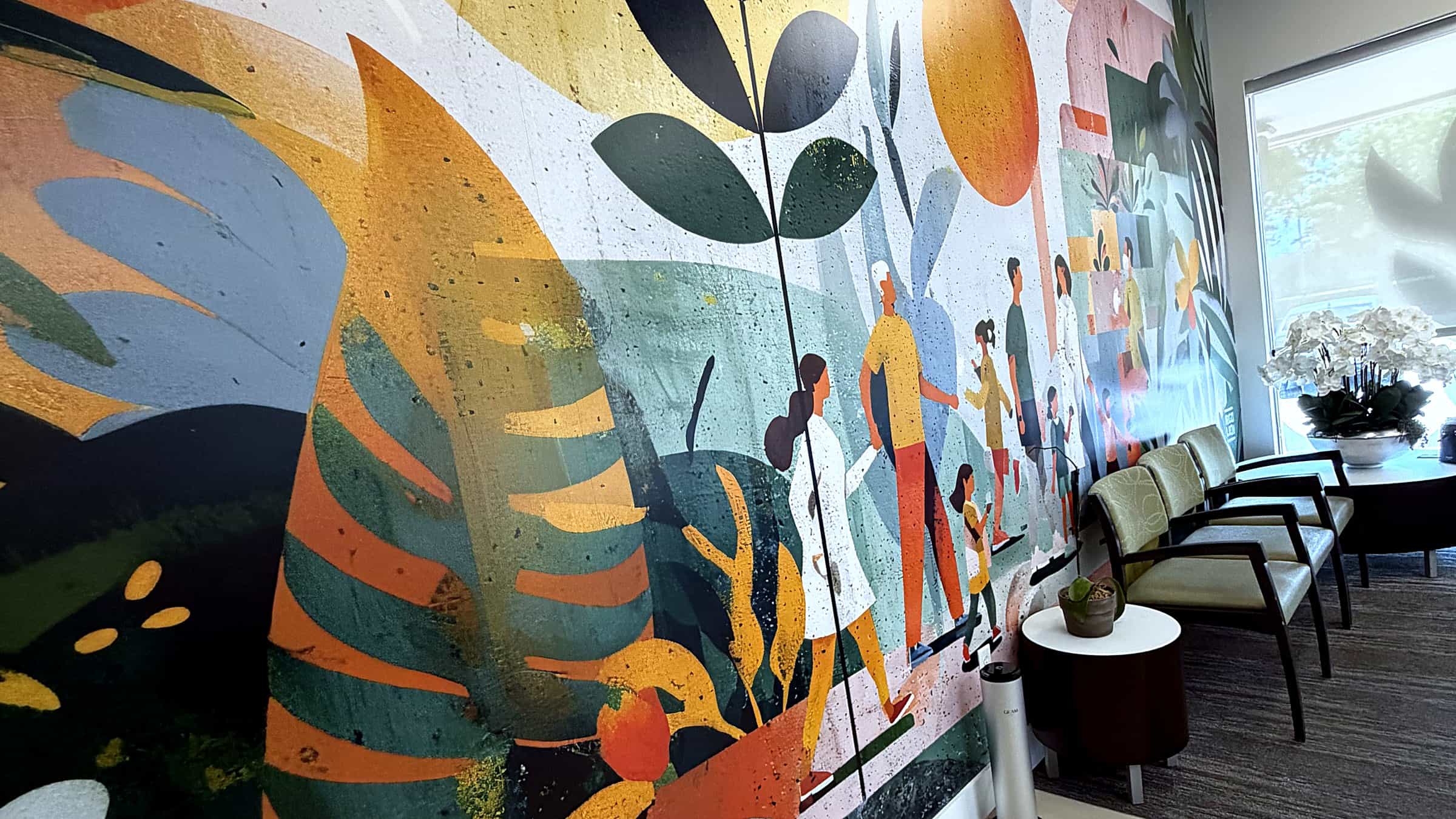 PassQual Health waiting area in Miami Gardens with the community wellness mural